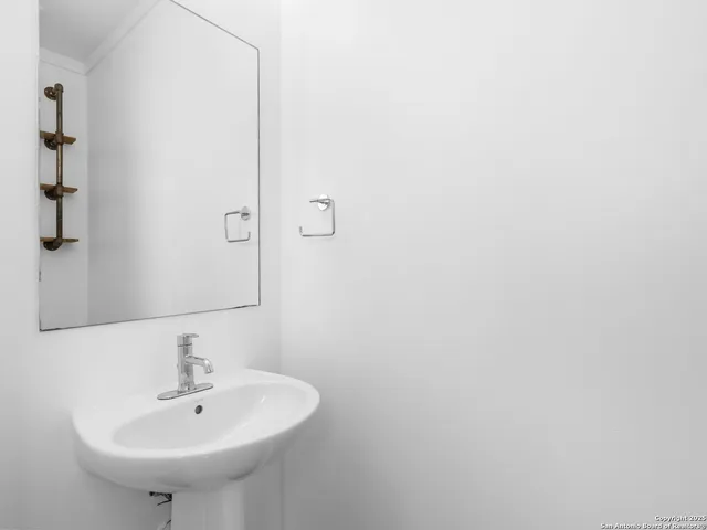a bathroom with a sink and a mirror