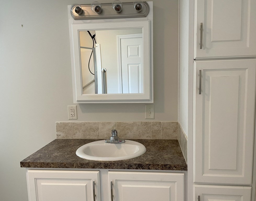 15 2nd Street Merrimac, MA 01860 - Photo 20 of 31 a bathroom with a granite countertop sink and a mirror