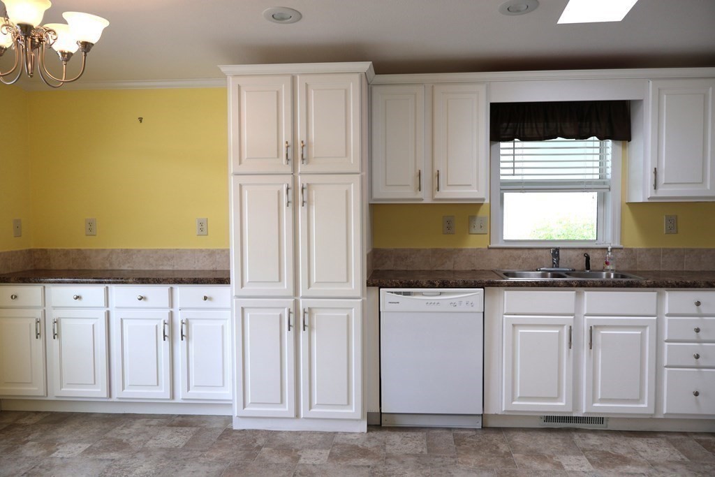 15 2nd Street Merrimac, MA 01860 - Photo 4 of 31 a kitchen with white cabinets and sink