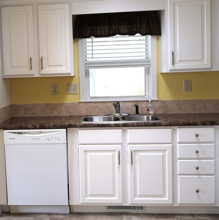15 2nd Street Merrimac, MA 01860 - Photo 5 of 31 a kitchen with granite countertop white cabinets and sink