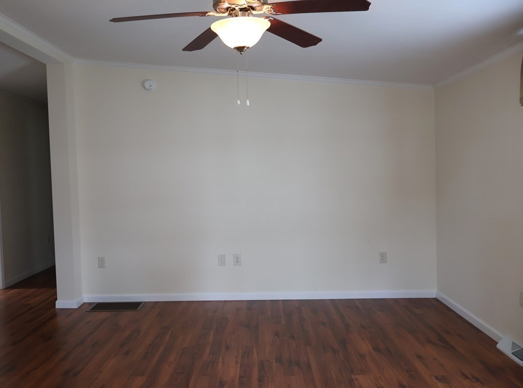 15 2nd Street Merrimac, MA 01860 - Photo 10 of 31 an empty room with wooden floor and chandelier fan