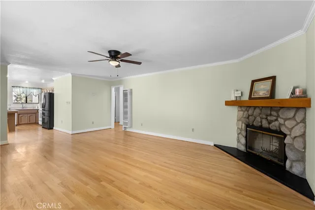 a view of an empty room with a fireplace and a chandelier