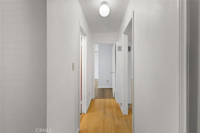 a view of hallway with wooden floor