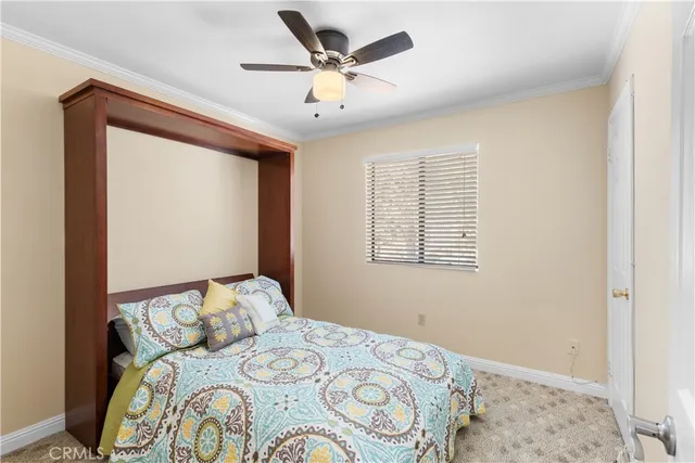 a bedroom with a bed and a large window