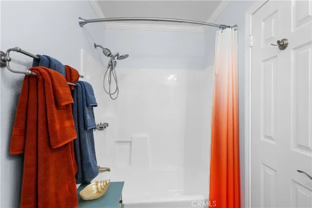 a bathroom with a shower and a shower curtain