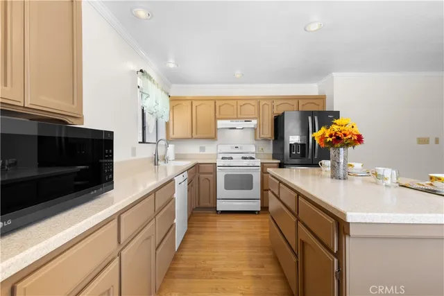 a kitchen with a sink cabinets and stainless steel appliances
