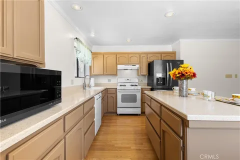 a kitchen with a sink cabinets and stainless steel appliances