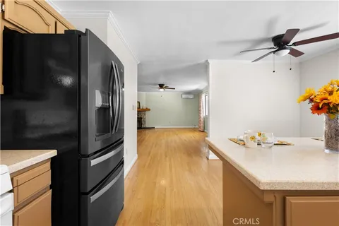 a kitchen view with granite countertop a refrigerator and a stove