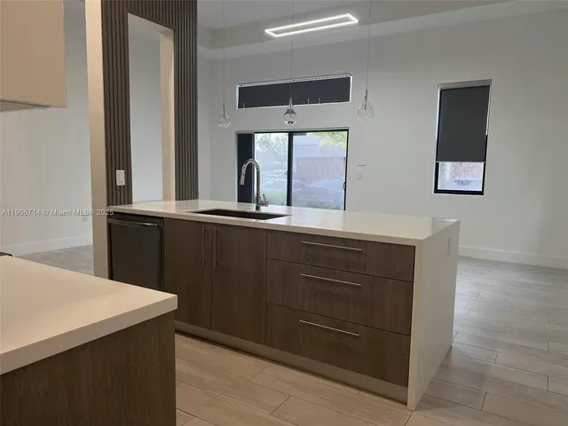 a kitchen with a sink and a mirror