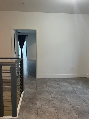 a view of a bathroom with mirror and shower