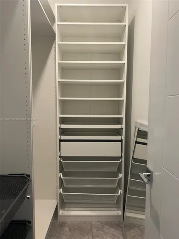 a front view of a house with a yard and fountain in middle of the house