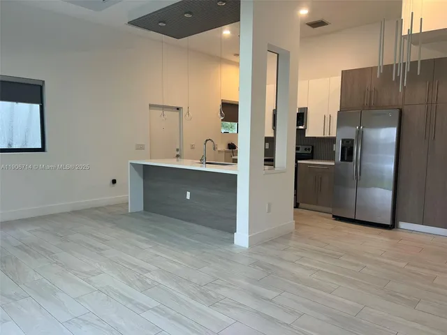 a kitchen with stainless steel appliances a refrigerator and a sink
