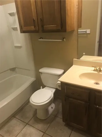 a bathroom with a sink a toilet and bathtub