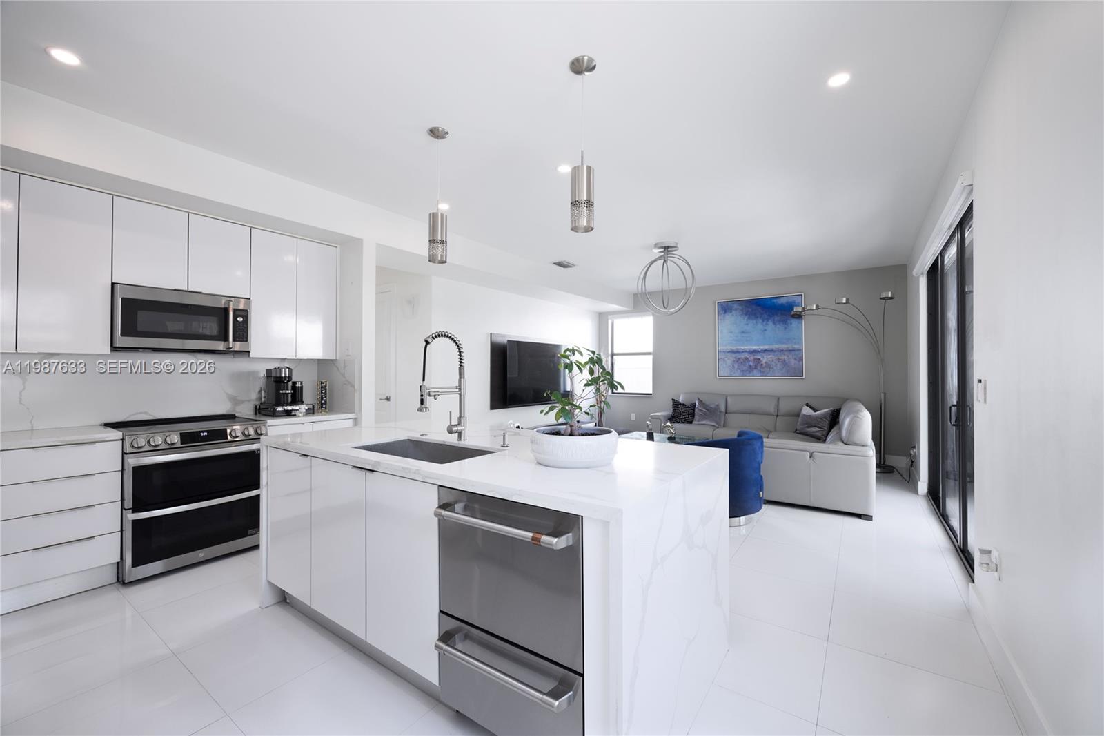 2981 Southwest 149th Avenue Miami, FL 33185 - Photo 11 of 30 a kitchen with a sink stove and microwave