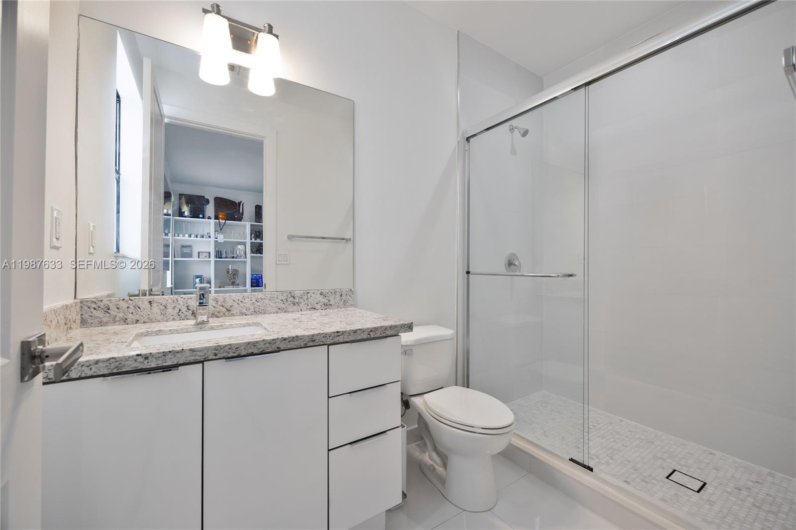 2981 Southwest 149th Avenue Miami, FL 33185 - Photo 15 of 30 a bathroom with a granite countertop sink toilet and shower