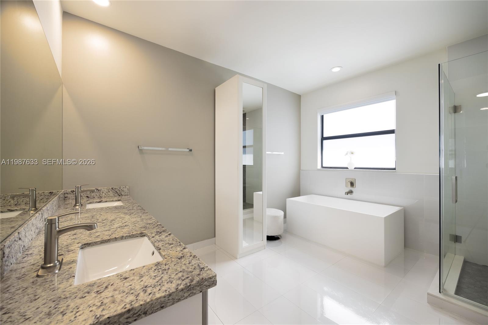 2981 Southwest 149th Avenue Miami, FL 33185 - Photo 20 of 30 a spacious bathroom with a granite countertop sink and a mirror