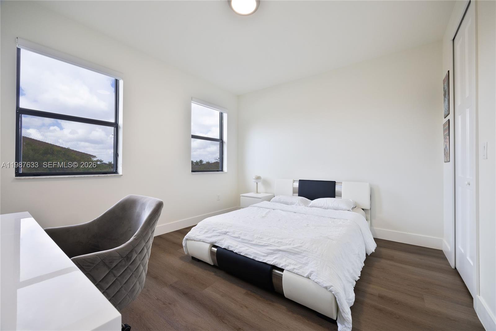 2981 Southwest 149th Avenue Miami, FL 33185 - Photo 23 of 30 a bedroom with a bed and wooden floor