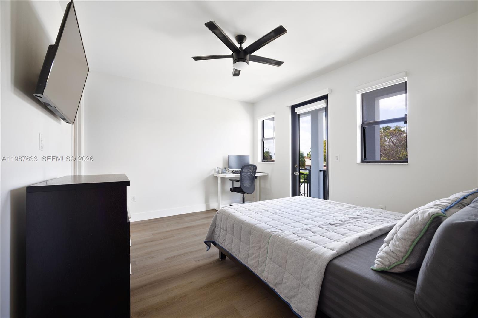 2981 Southwest 149th Avenue Miami, FL 33185 - Photo 25 of 30 a bedroom with a bed and a flat screen tv