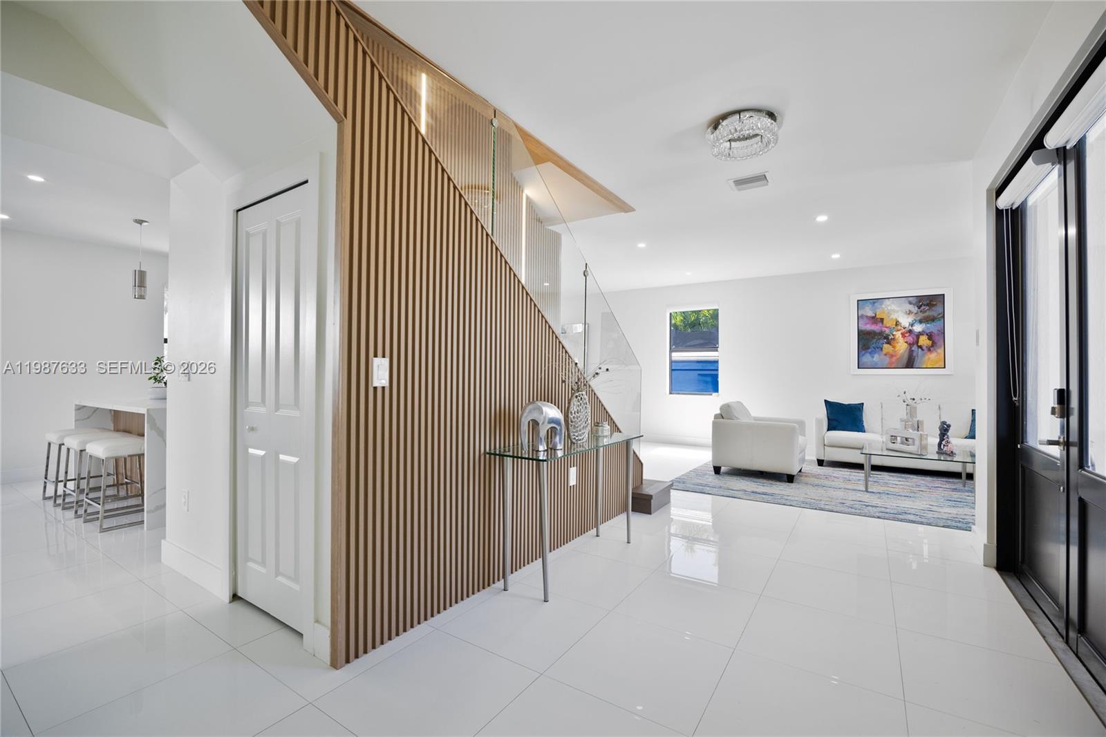 2981 Southwest 149th Avenue Miami, FL 33185 - Photo 4 of 30 a hallway with white cabinets and black stainless steel appliances