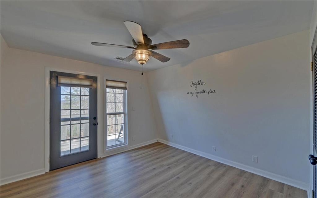 1492 Ivy Mountain Road Clarkesville, GA 30523 - Photo 19 of 53 wooden floor in an empty room with a window