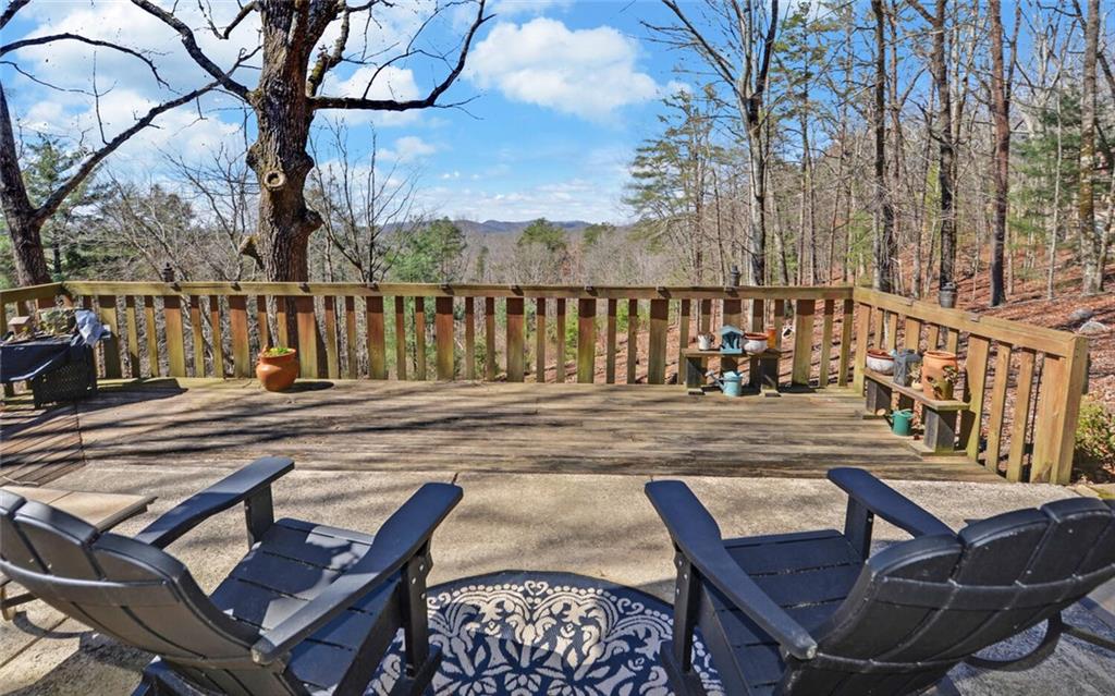 1492 Ivy Mountain Road Clarkesville, GA 30523 - Photo 22 of 53 a view of a chairs and table on the deck