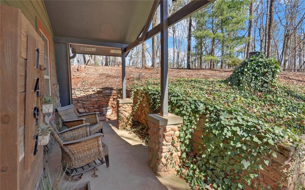 1492 Ivy Mountain Road Clarkesville, GA 30523 - Photo 33 of 53 a view of a porch with chairs and backyard