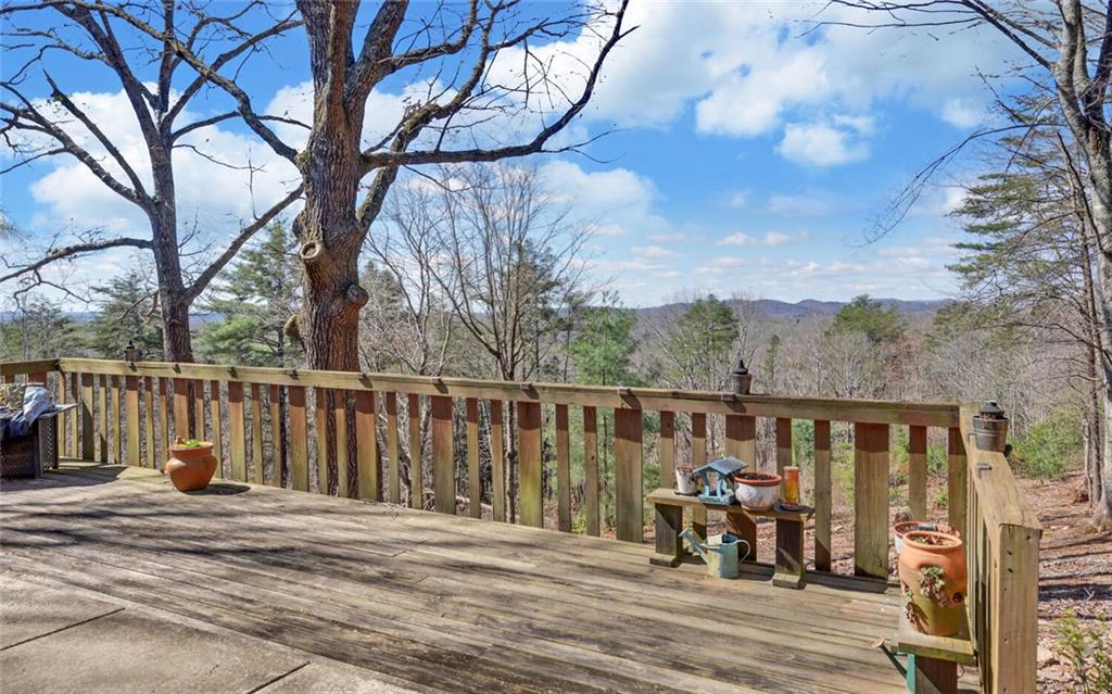 1492 Ivy Mountain Road Clarkesville, GA 30523 - Photo 35 of 53 a view of a balcony with chairs and wooden fence