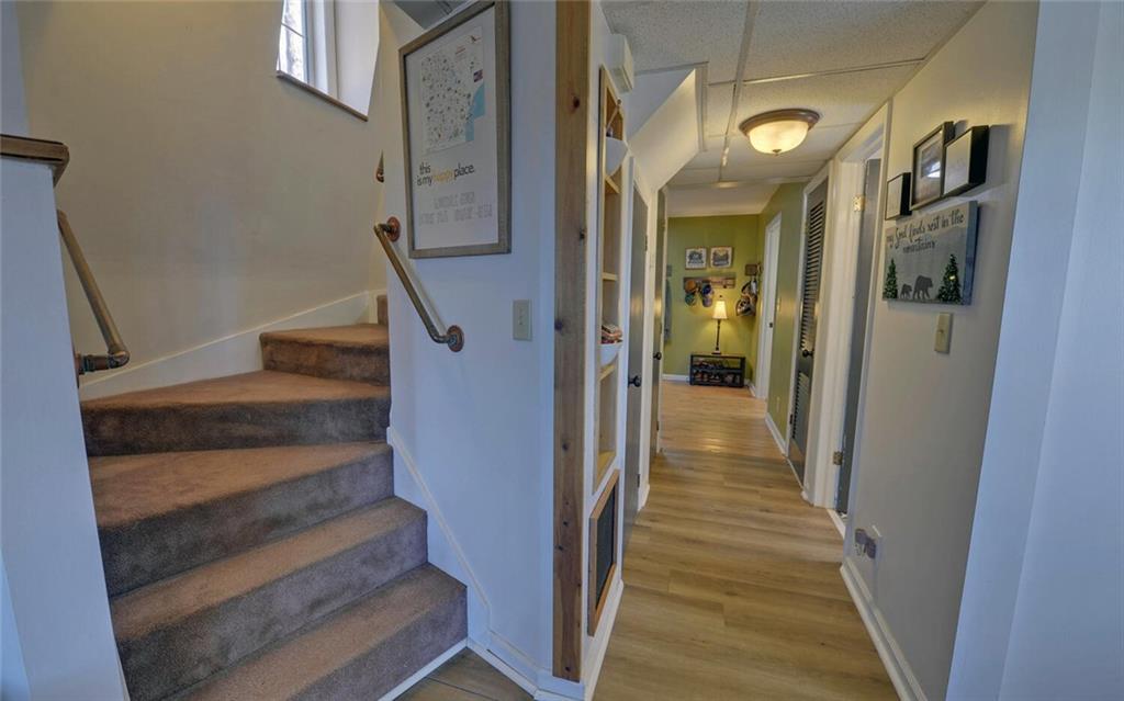 1492 Ivy Mountain Road Clarkesville, GA 30523 - Photo 7 of 53 a view of a hallway with wooden floor and staircase