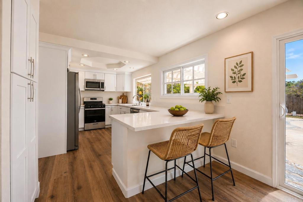 4595 Blackwell Road Oceanside, CA 92056 - Photo 13 of 47 a kitchen with sink a microwave and refrigerator