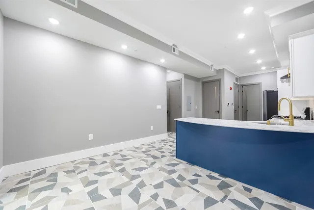 a kitchen with a stove a refrigerator and a sink