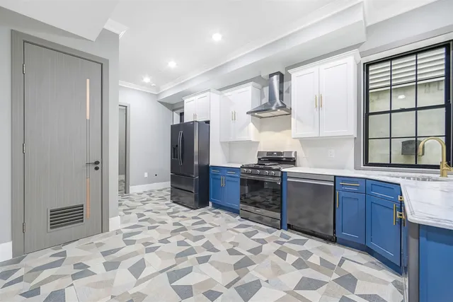 a kitchen with stainless steel appliances granite countertop a refrigerator and a stove