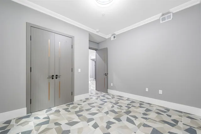 a view of a big room with wooden cabinet and bedroom shower