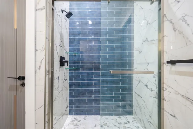 a view of a bathroom with sink and shower