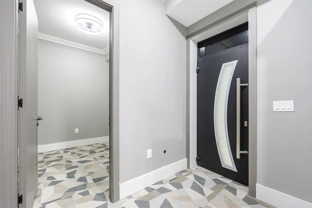 a view of a hallway with couch and wooden floor