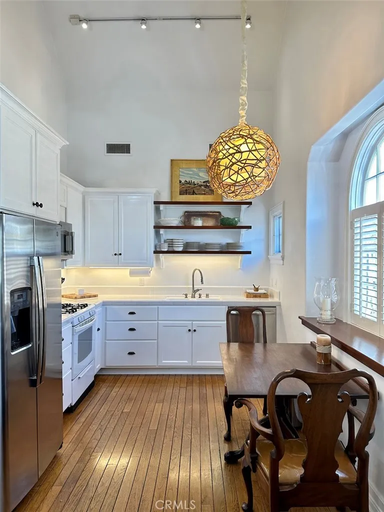 28 Beacon Bay Newport Beach, CA 92660 - Photo 6 of 15 a kitchen with cabinets a sink and appliances