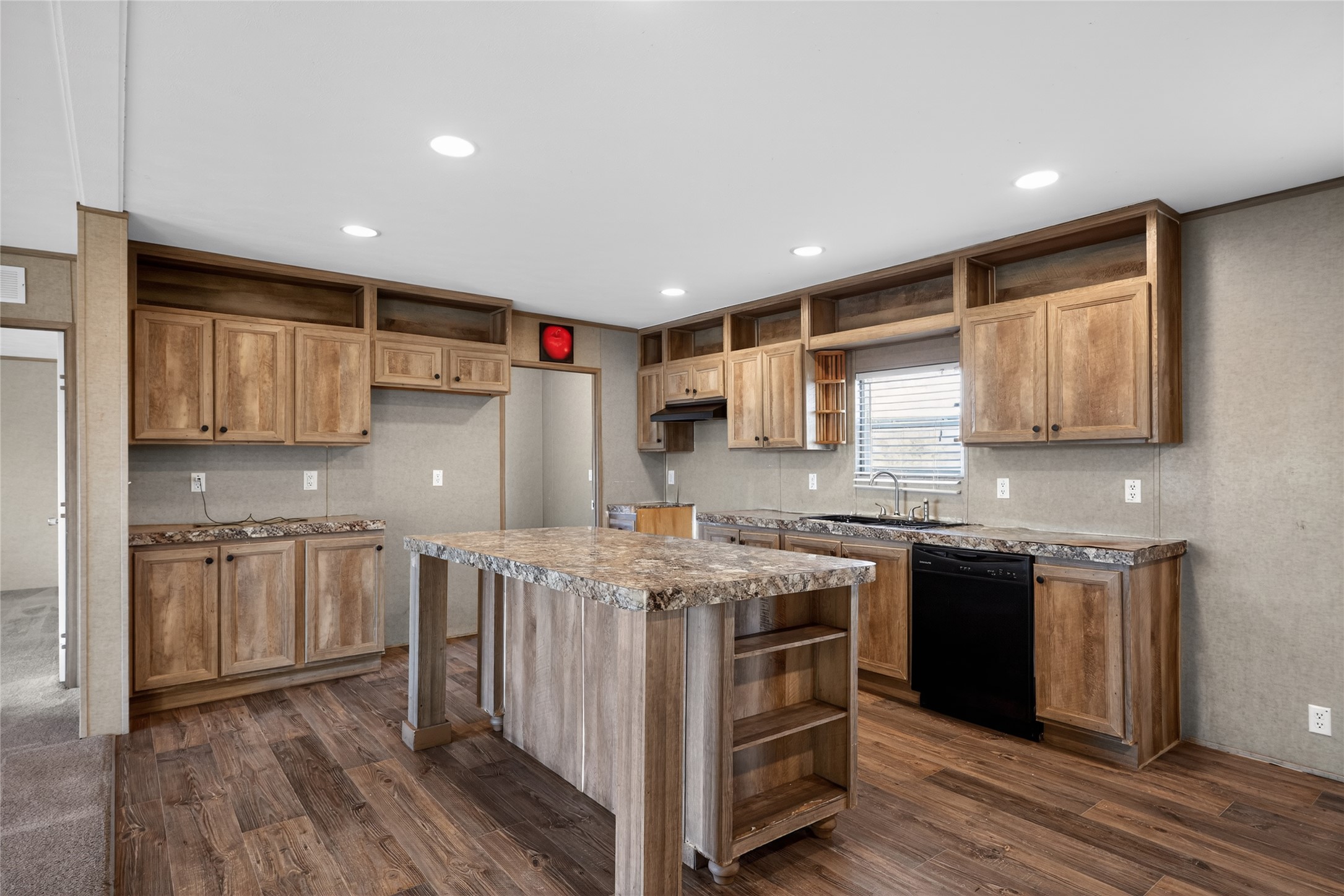 2674 Cotton Gin Road Kyle, TX 78640 - Photo 21 of 30 Kitchen featuring open shelves, black dishwasher, a kitchen island, dark wood-type flooring, and recessed lighting