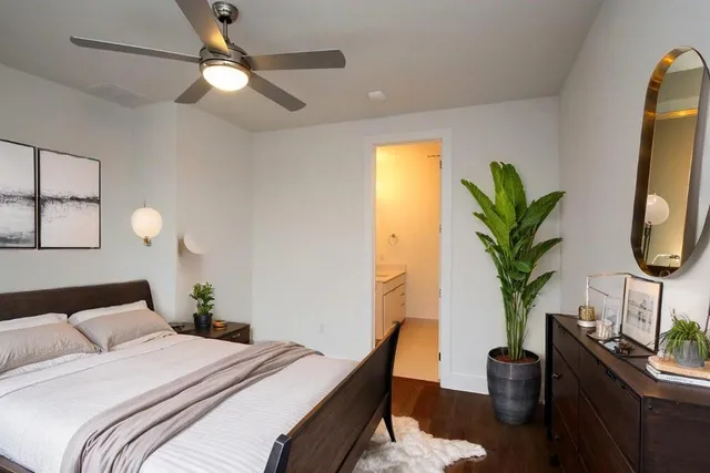 a bedroom with bed and a potted plant