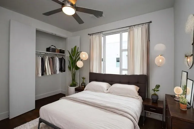 a bedroom with a bed and a chandelier