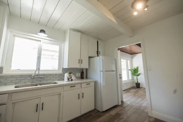 a kitchen with refrigerator a sink and a window