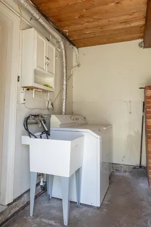 a bathroom with a sink a chair and a mirror