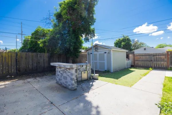 a view of a backyard with wooden fence