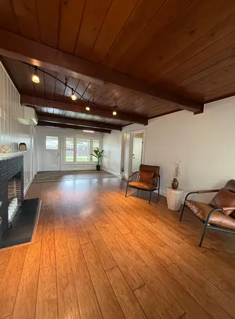 a room with wooden floor and furniture