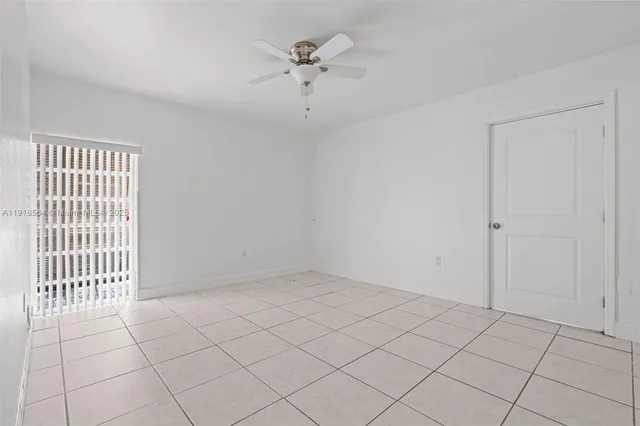 a view of an empty room and a window