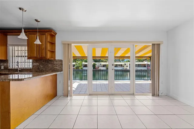 a open kitchen with granite countertop a sink and a stove top oven