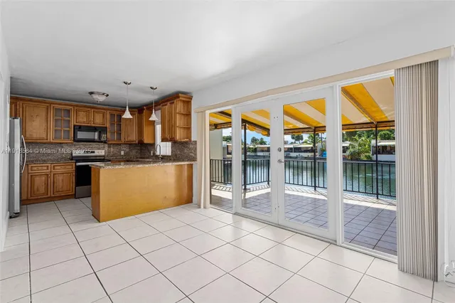 a kitchen with stainless steel appliances wooden cabinets a stove top oven and a refrigerator