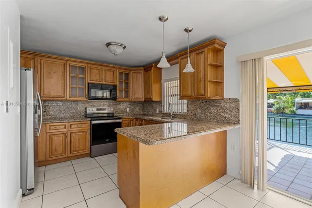 a kitchen with stainless steel appliances granite countertop a sink stove and cabinets