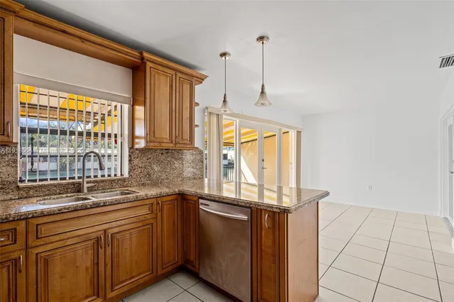 a kitchen with stainless steel appliances a sink a stove and a refrigerator