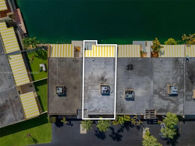 an aerial view of a house with swimming pool and a yard