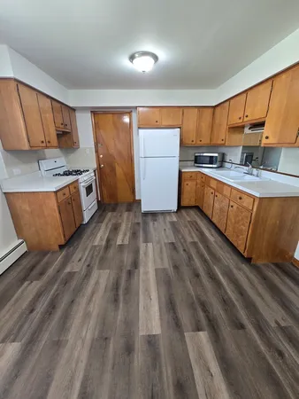 a kitchen with stainless steel appliances granite countertop a stove a sink and a refrigerator