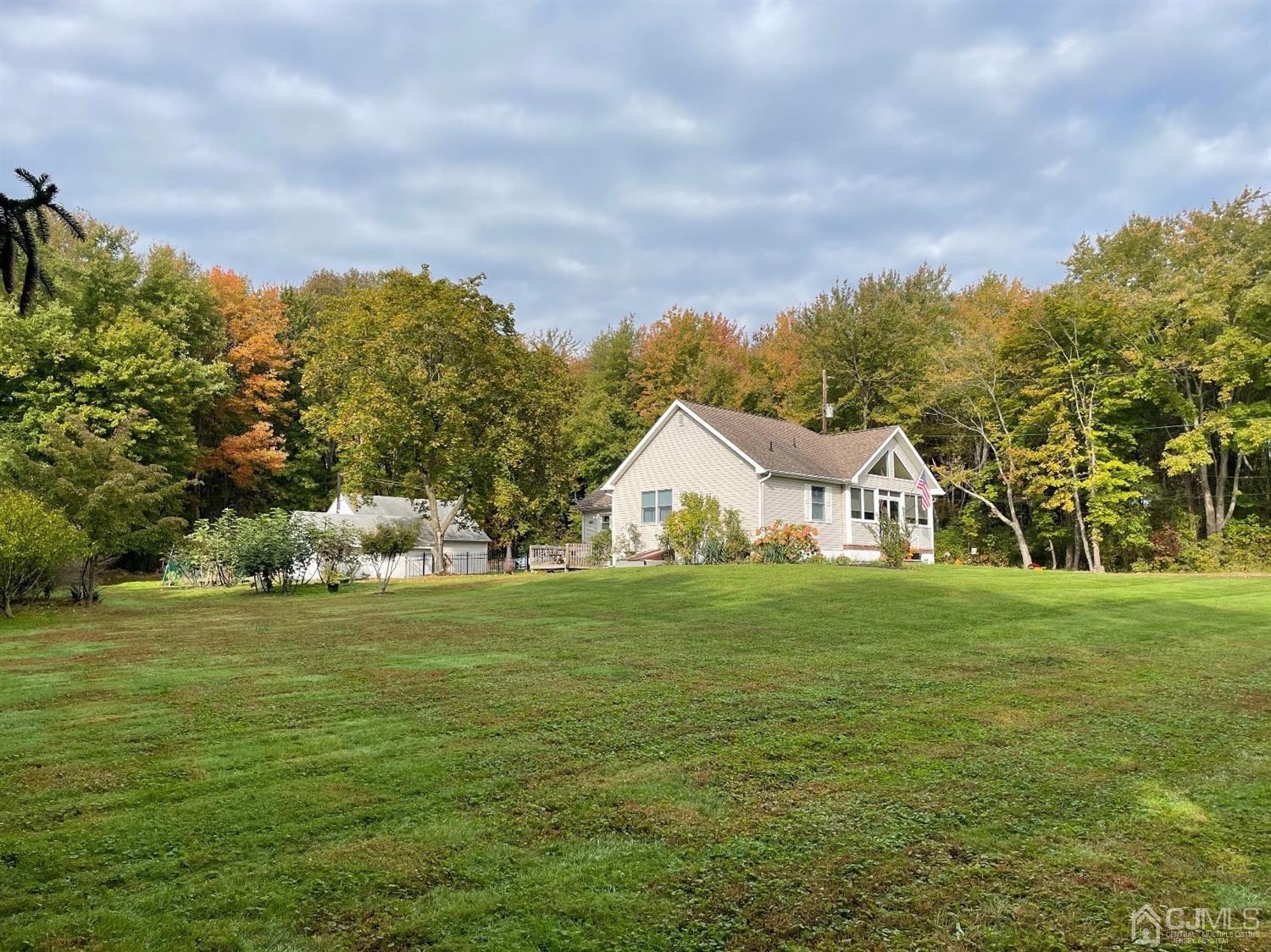 234 Morganville Road Old Bridge, NJ 07747 - Photo 2 of 52 a view of a big yard with a house in the background